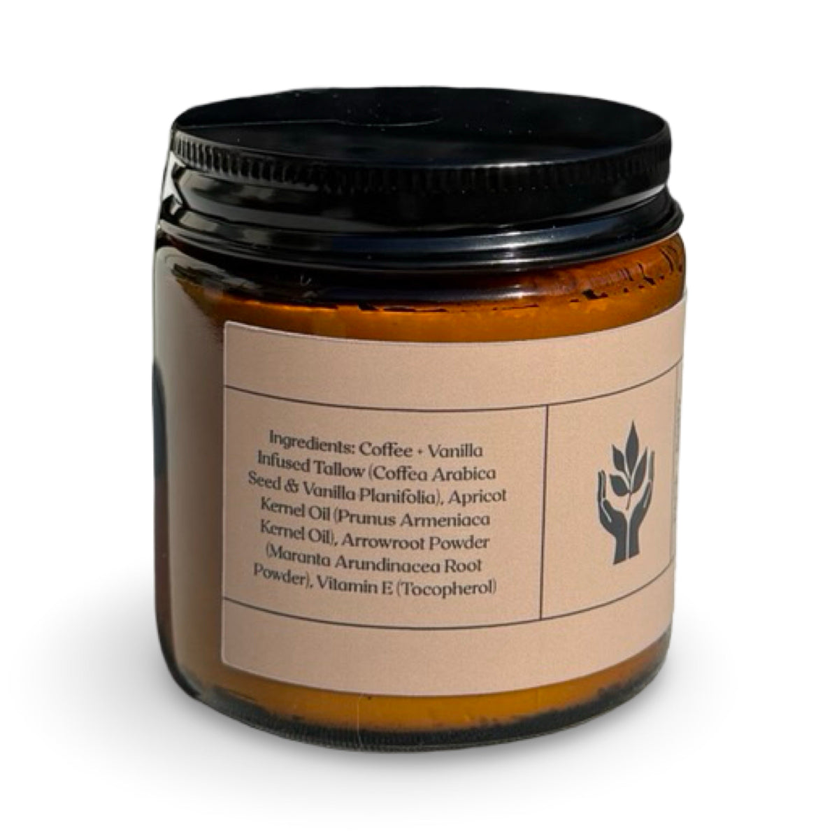 An amber glass jar of Present Body Co. Coffee + Vanilla Whipped Tallow Balm with a black screw-on lid and a beige paper label, photographed on a clean white background.