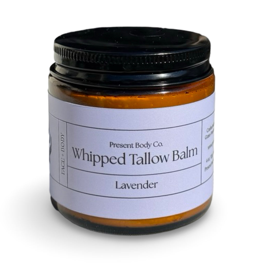 Lavender whipped tallow balm by Present Body Co., amber jar with black lid.