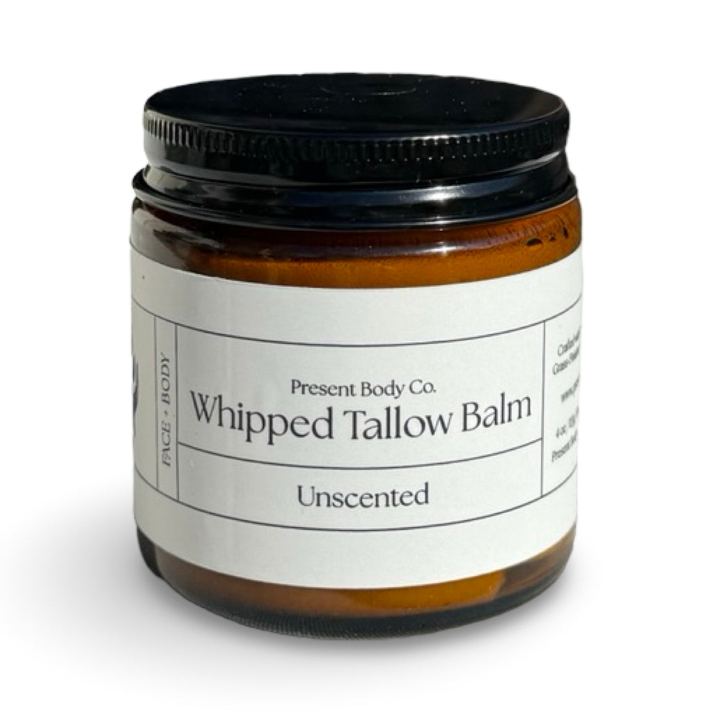 Unscented whipped tallow balm by Present Body Co., amber jar with black lid.