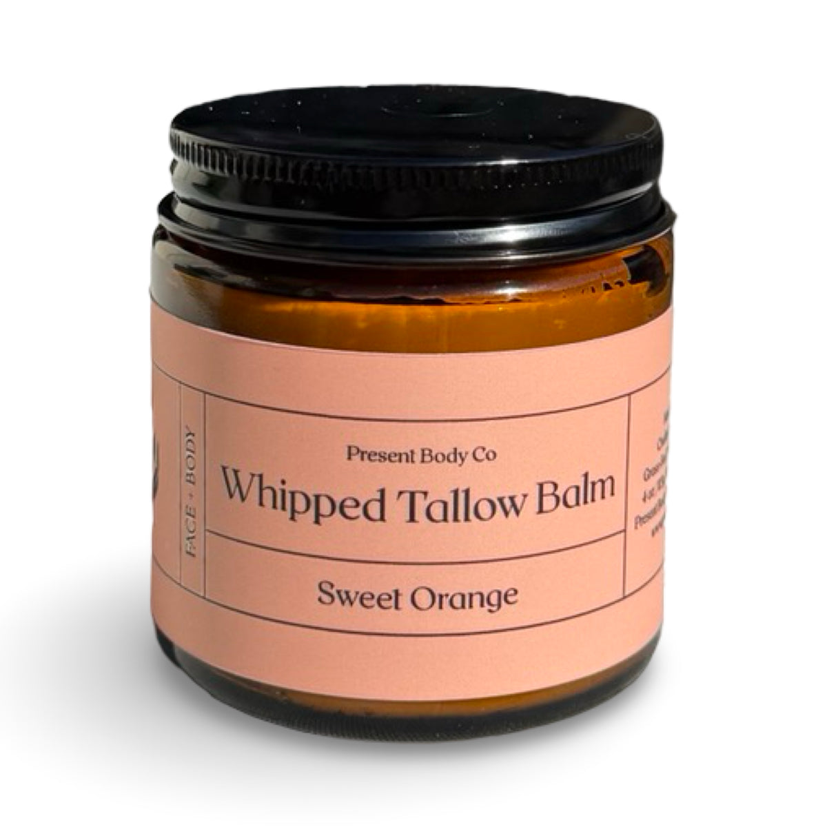 Sweet orange whipped tallow balm by Present Body Co., amber jar with black lid.