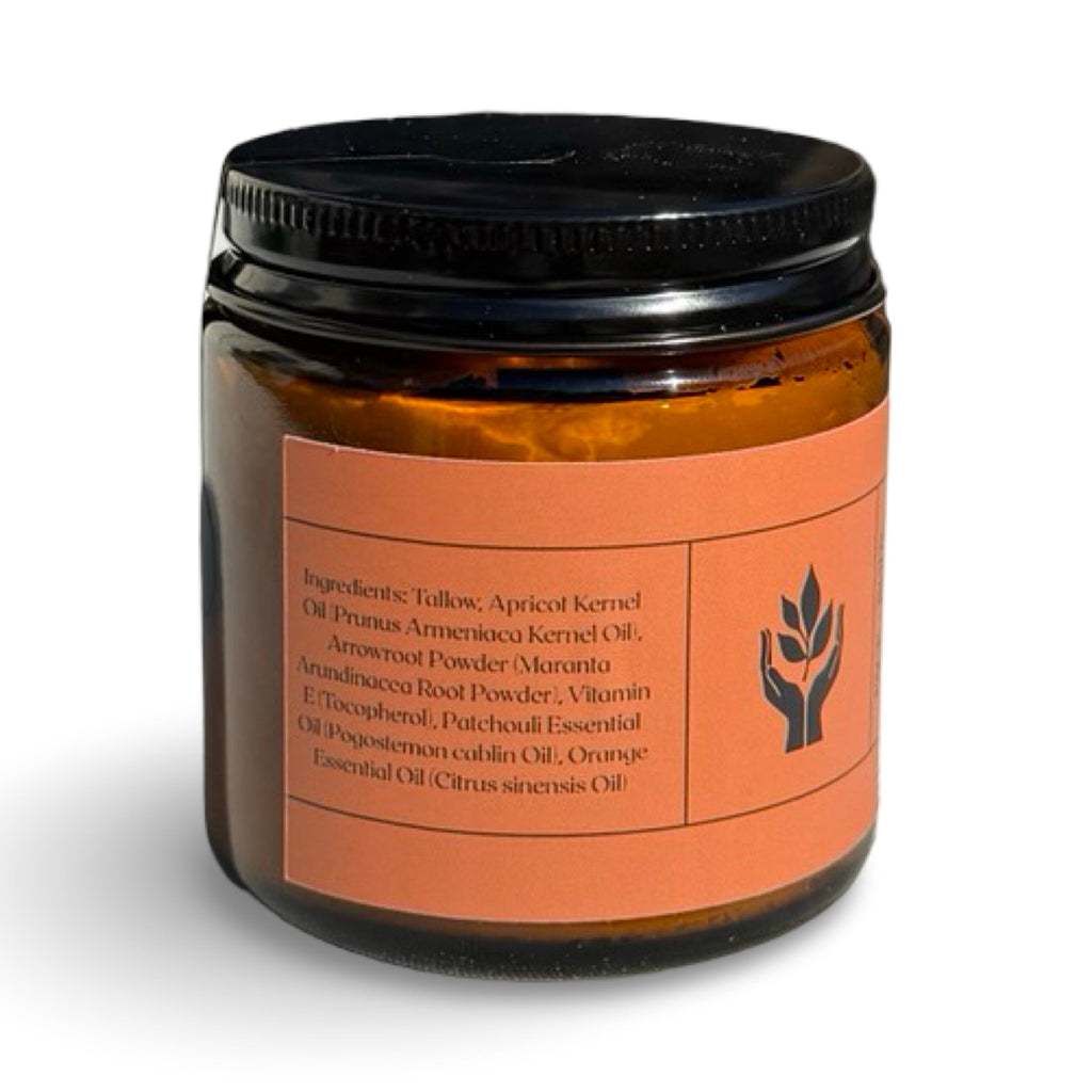 An amber glass jar with a black screw-on lid and a terracotta-colored label, photographed on a clean white background.