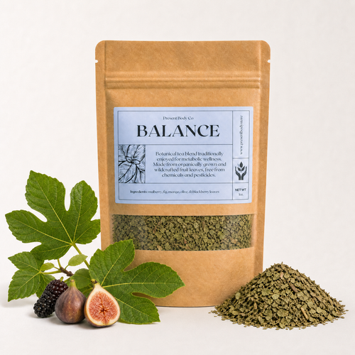 A kraft paper stand-up pouch labeled 'Balance' by Desert Botany Co, shown on a clean white background with fig leaves, figs, and a small pile of dried green herbs in front.