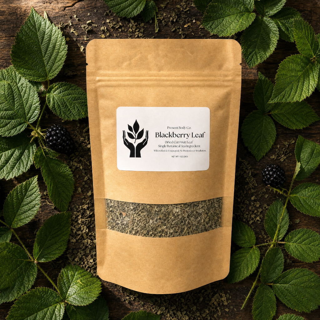 A kraft paper stand-up pouch labeled 'Blackberry Leaf' by Powerleaf Co, placed on a rustic wooden surface and surrounded by green leaves and blackberries.