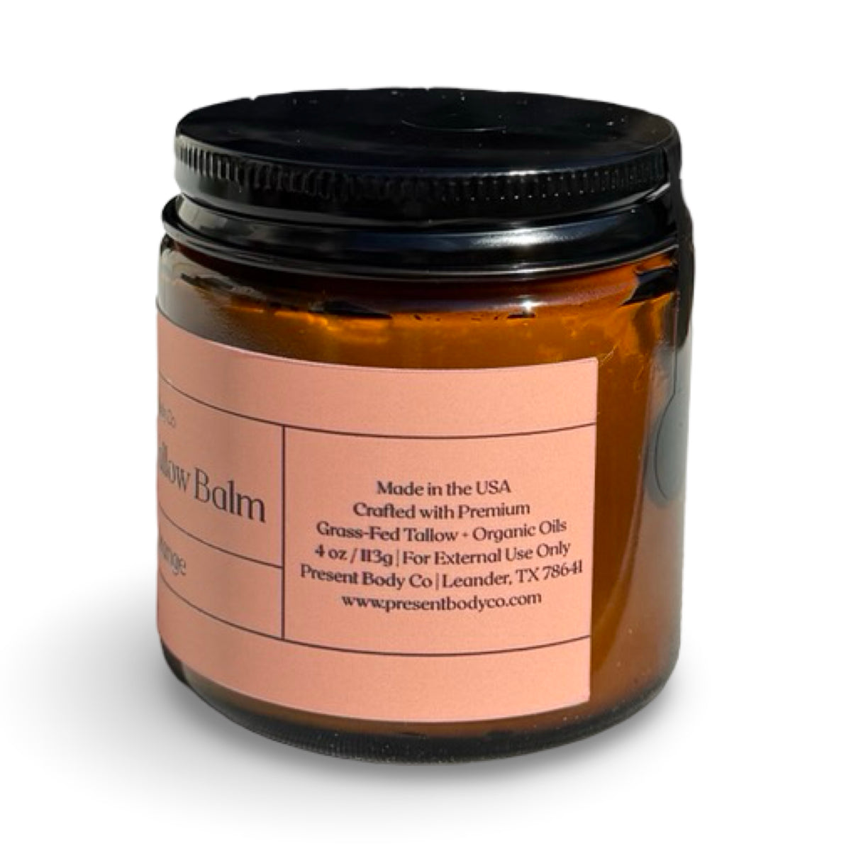 Close-up of Present Body Co. Sweet Orange grass fed tallow balm jar.