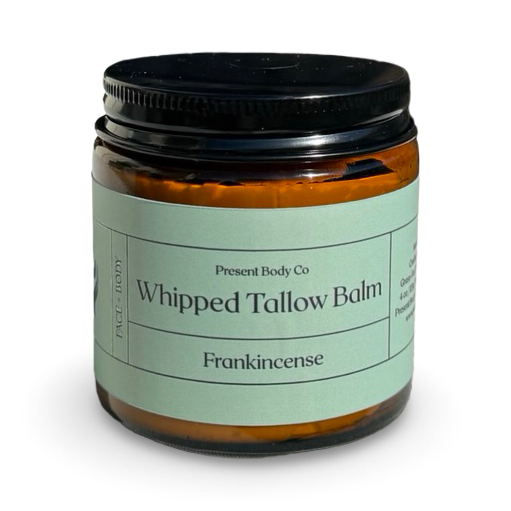 Frankincense whipped tallow balm by Present Body Co., amber jar with black lid.