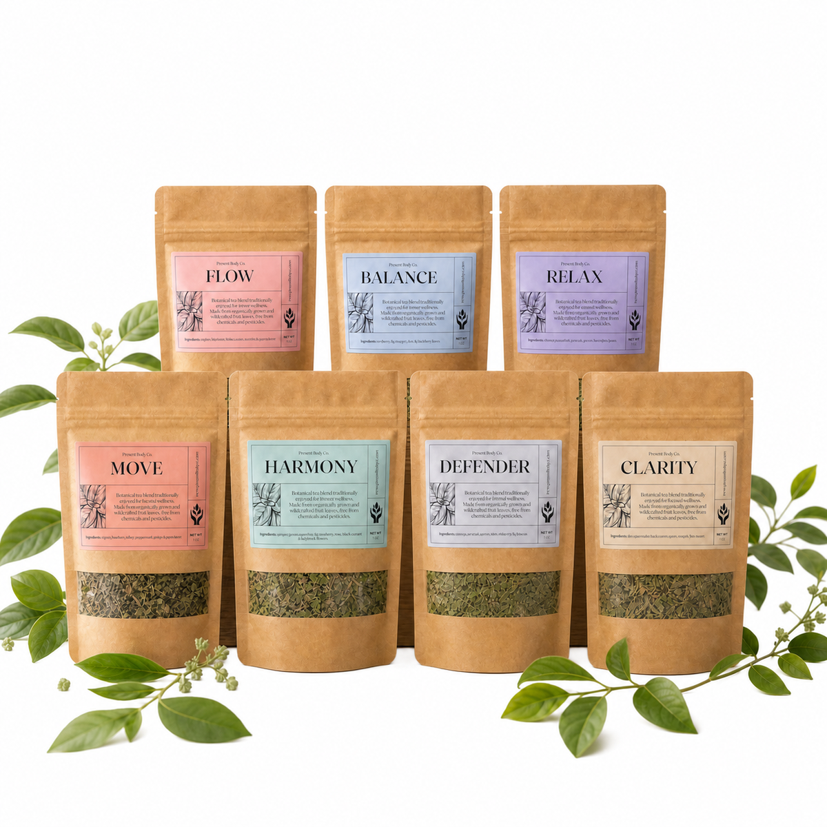 Seven kraft paper stand-up pouches of Present Body Co. tea blends arranged in two rows on a white background, with green leaves and small flowers placed around them. The front row includes Move, Harmony, Defender, and Clarity, while the back row includes Flow, Balance, and Relax.