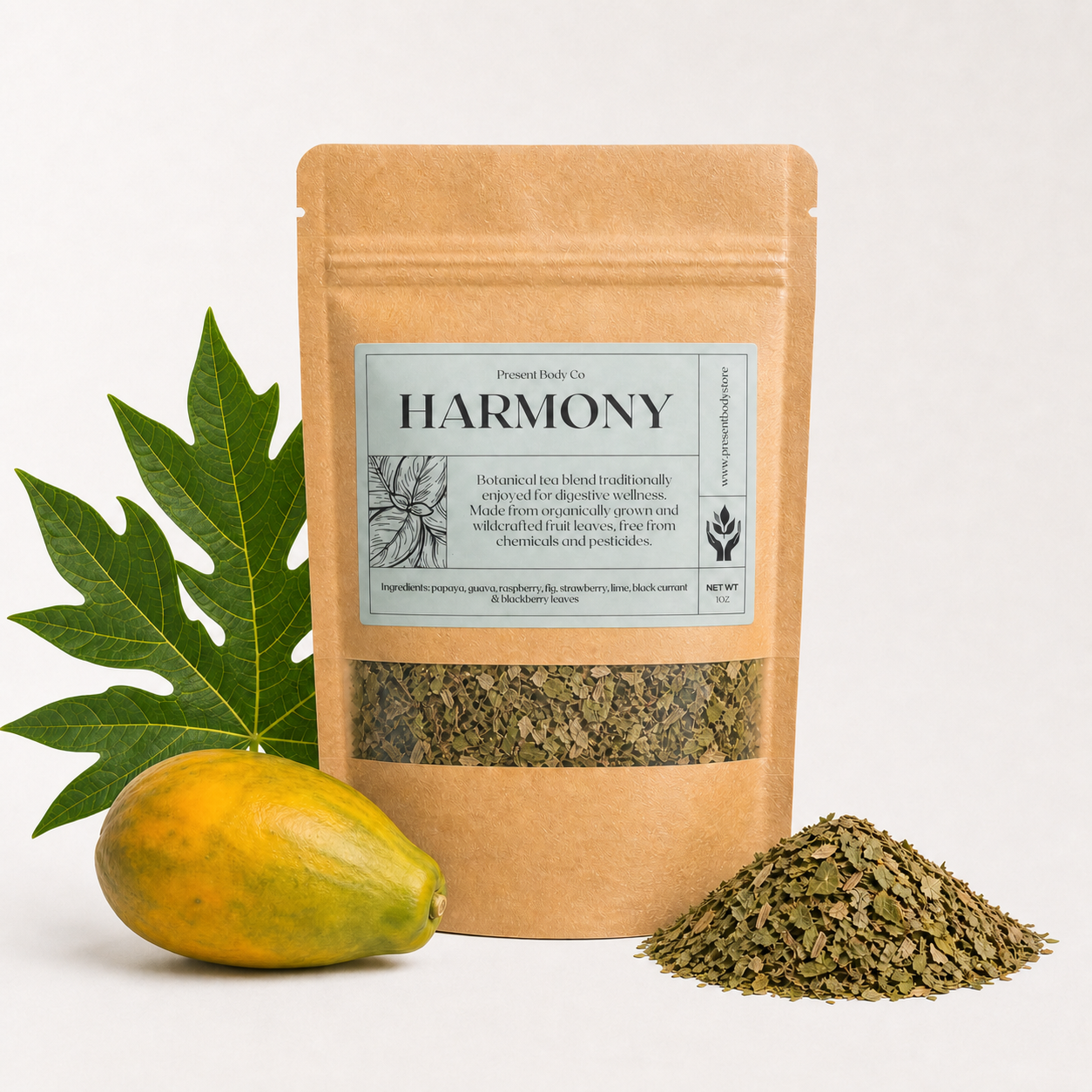 A kraft paper stand-up pouch labeled HARMONY by Pleasant Roots Co., shown with a green papaya and a pile of loose dried herbal blend on a clean white background.