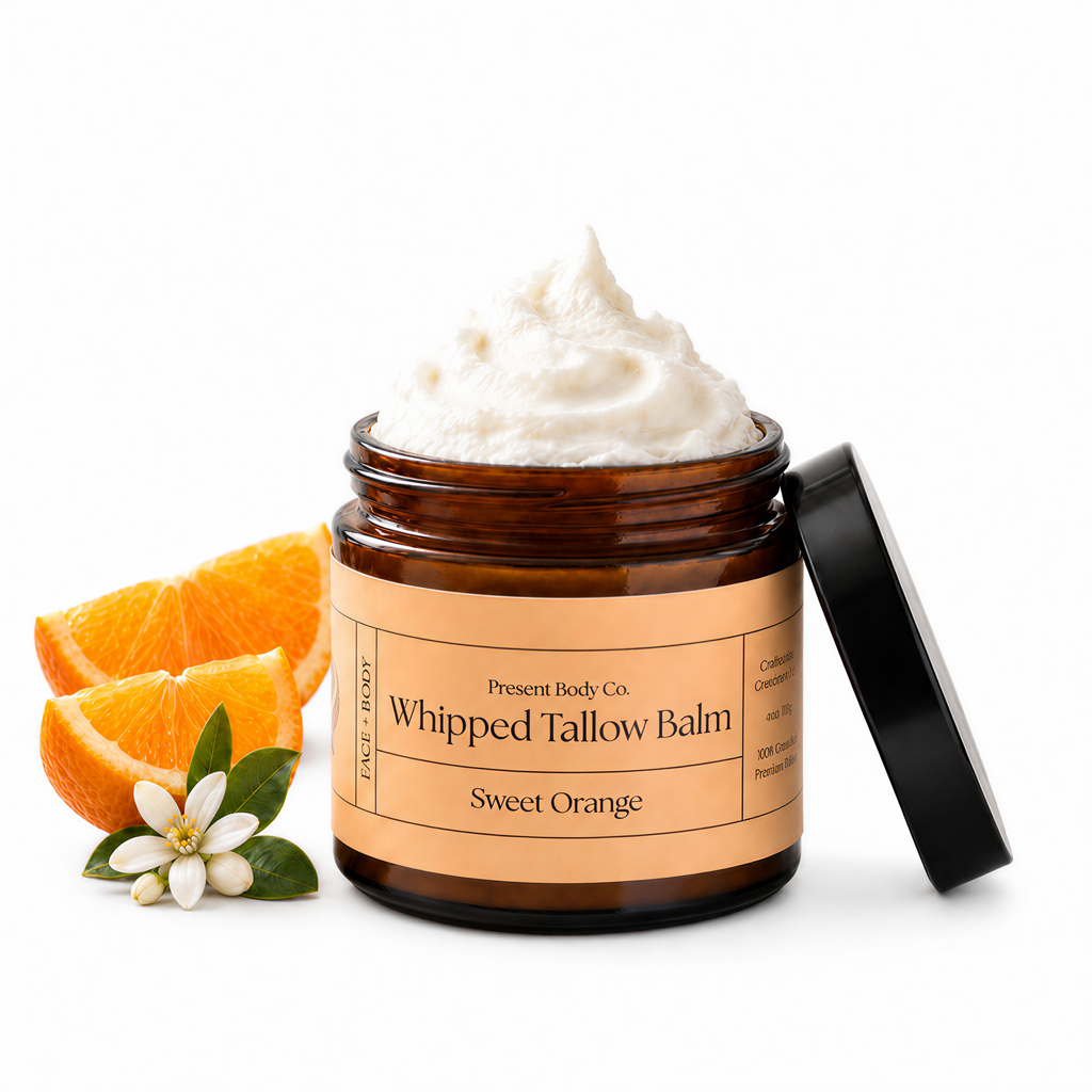 Present Body Co. Sweet Orange Whipped Tallow Balm in a 4 oz amber glass jar.