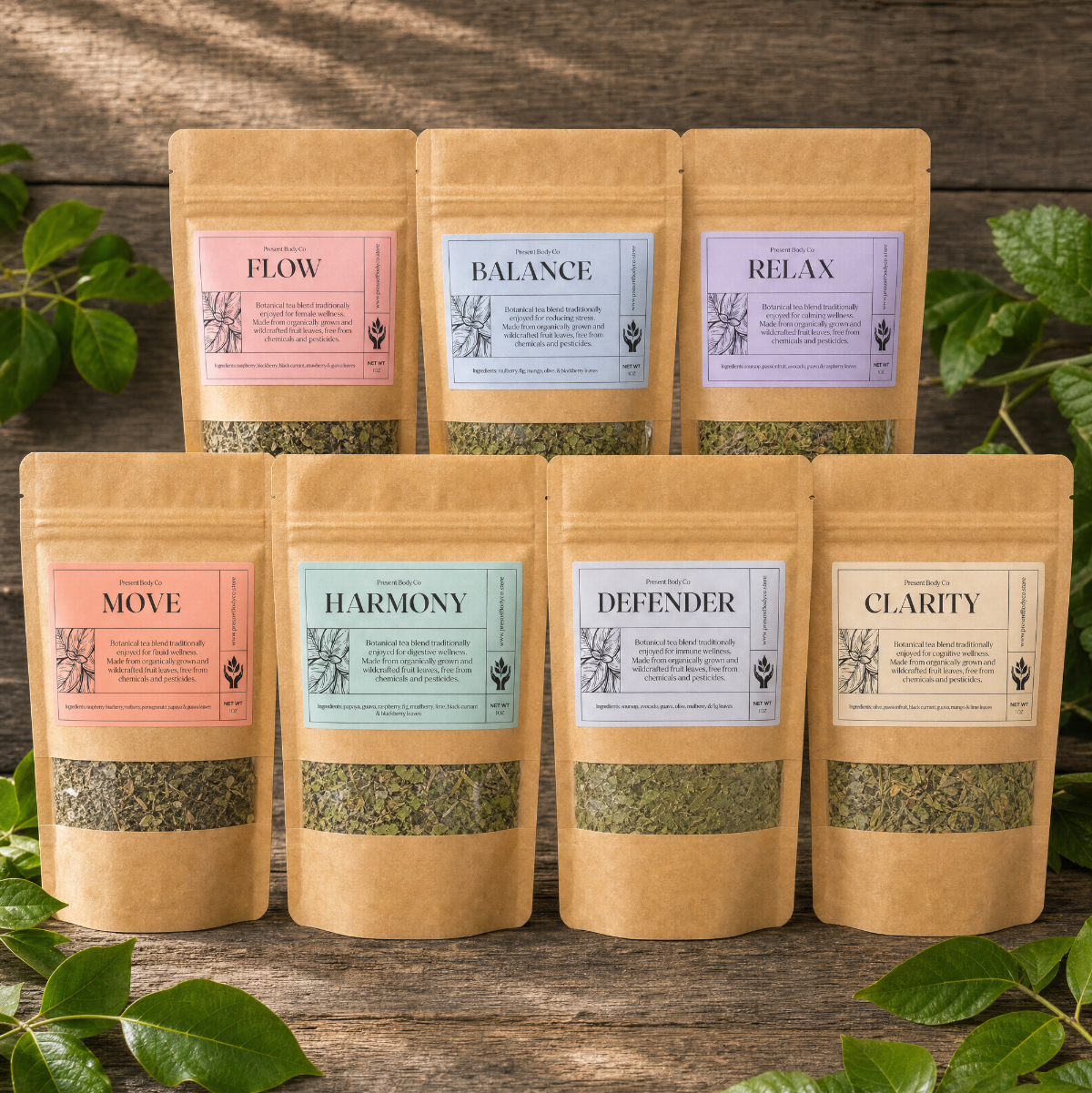 Six kraft paper stand-up pouches of herbal tea arranged on a rustic wooden surface with green leaves around them. The labels read Flow, Balance, Relax, Move, Harmony, Defender, and Clarity.