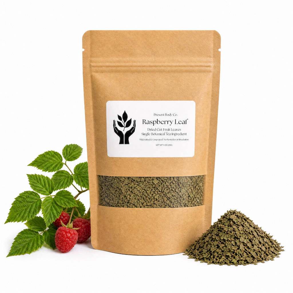 A kraft paper stand-up pouch of Raspberry Leaf by Present Body Co., shown on a white background with green leaves and red raspberries on the left and a small pile of dried green leaves on the right.
