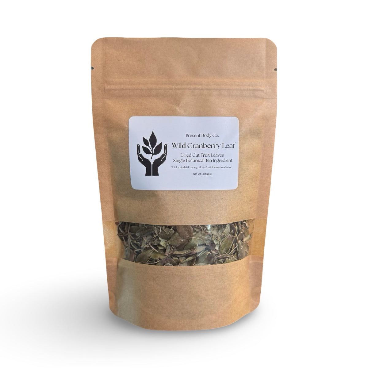 A stand-up kraft paper pouch of Present Body Co. Wild Cranberry Leaf, featuring a white label with black text and a clear window near the bottom showing the dried greenish-brown leaves inside, set against a plain white background.